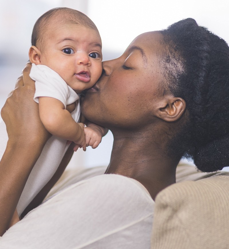 Mother kissing infant